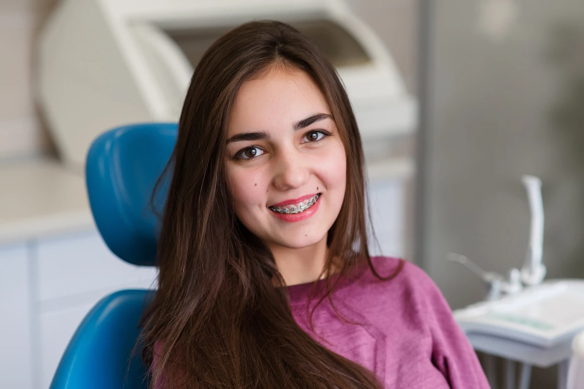 A smiling teenager wearing braces